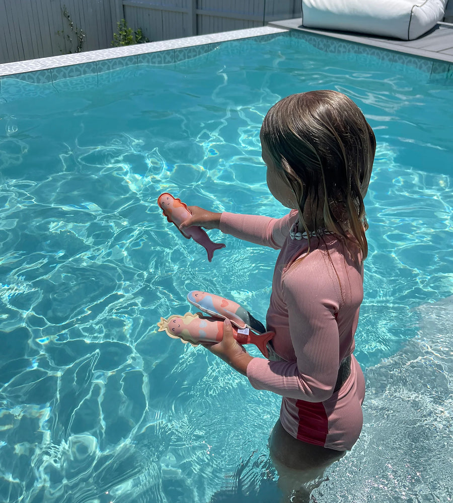 Child playing with toys in a pool