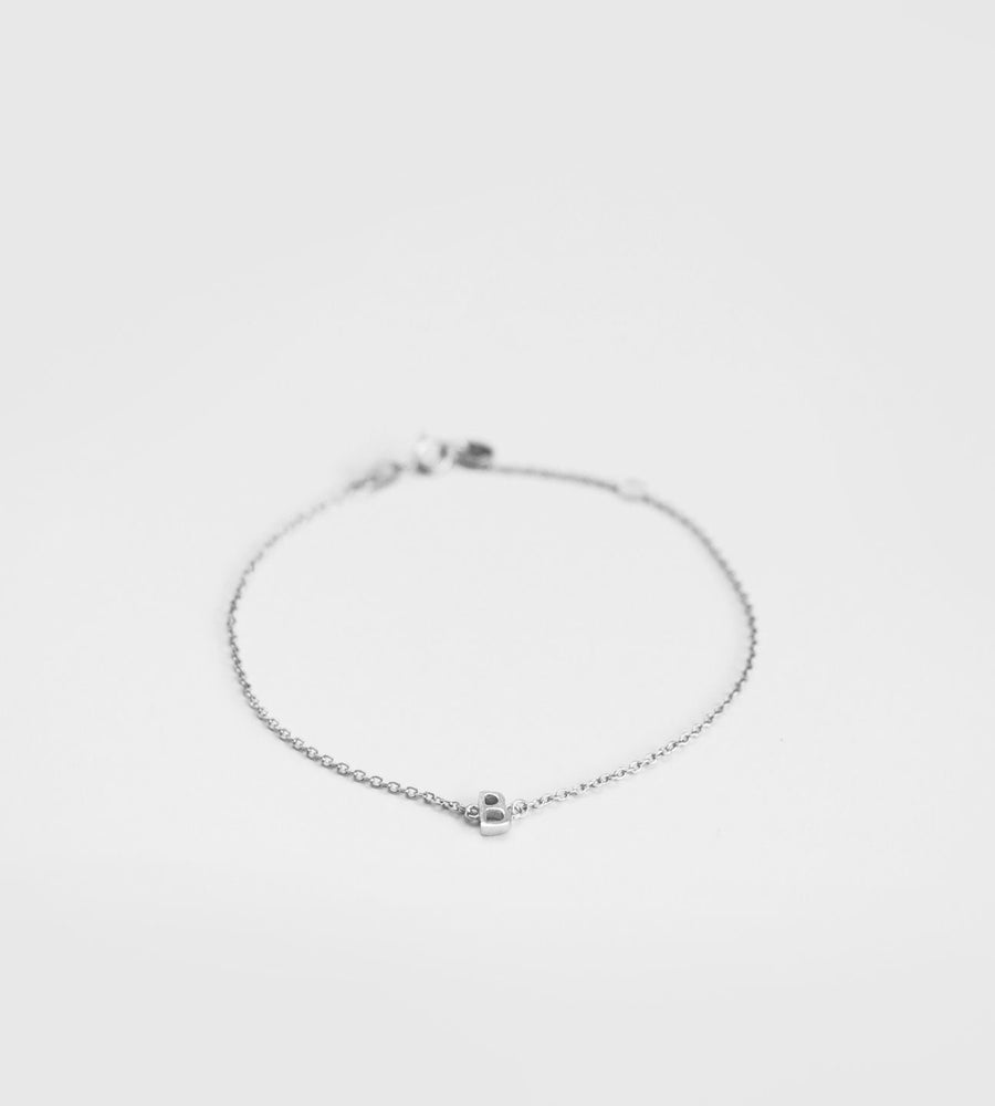 Silver bracelet on a light gray background