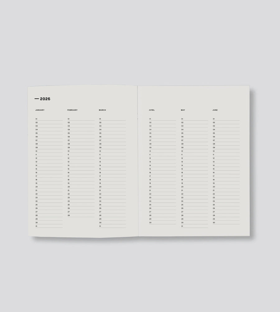 Calendar planner open to a page showing a grid layout on a light gray background