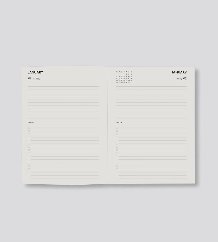 Open planner showing two pages for January on a light gray background