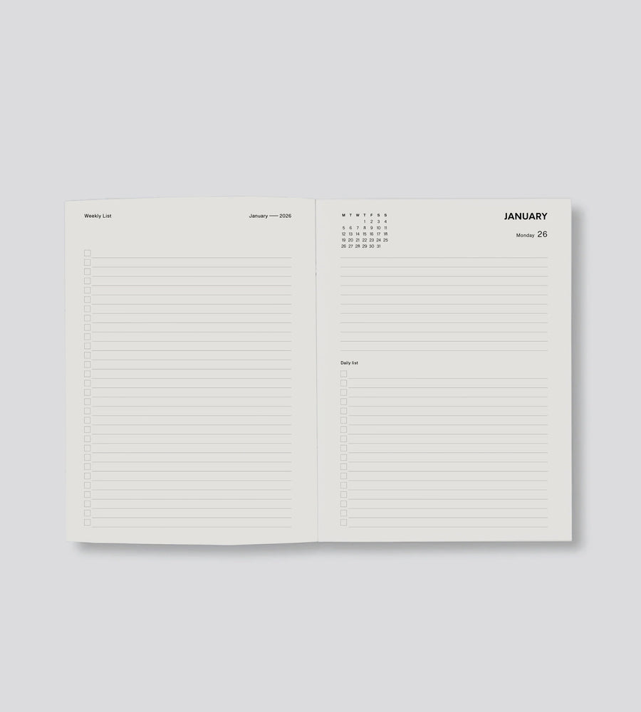 Open planner showing a monthly layout with a calendar and notes section on a light gray background