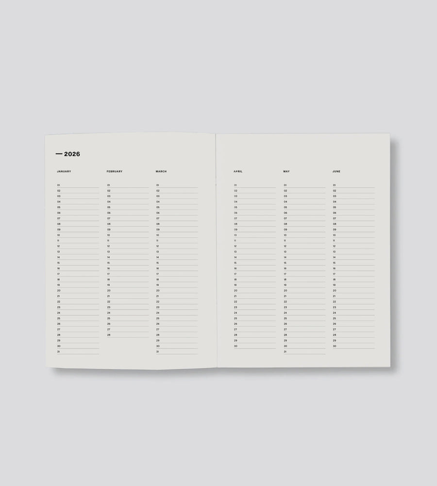 Open planner with calendar layout on a light gray background
