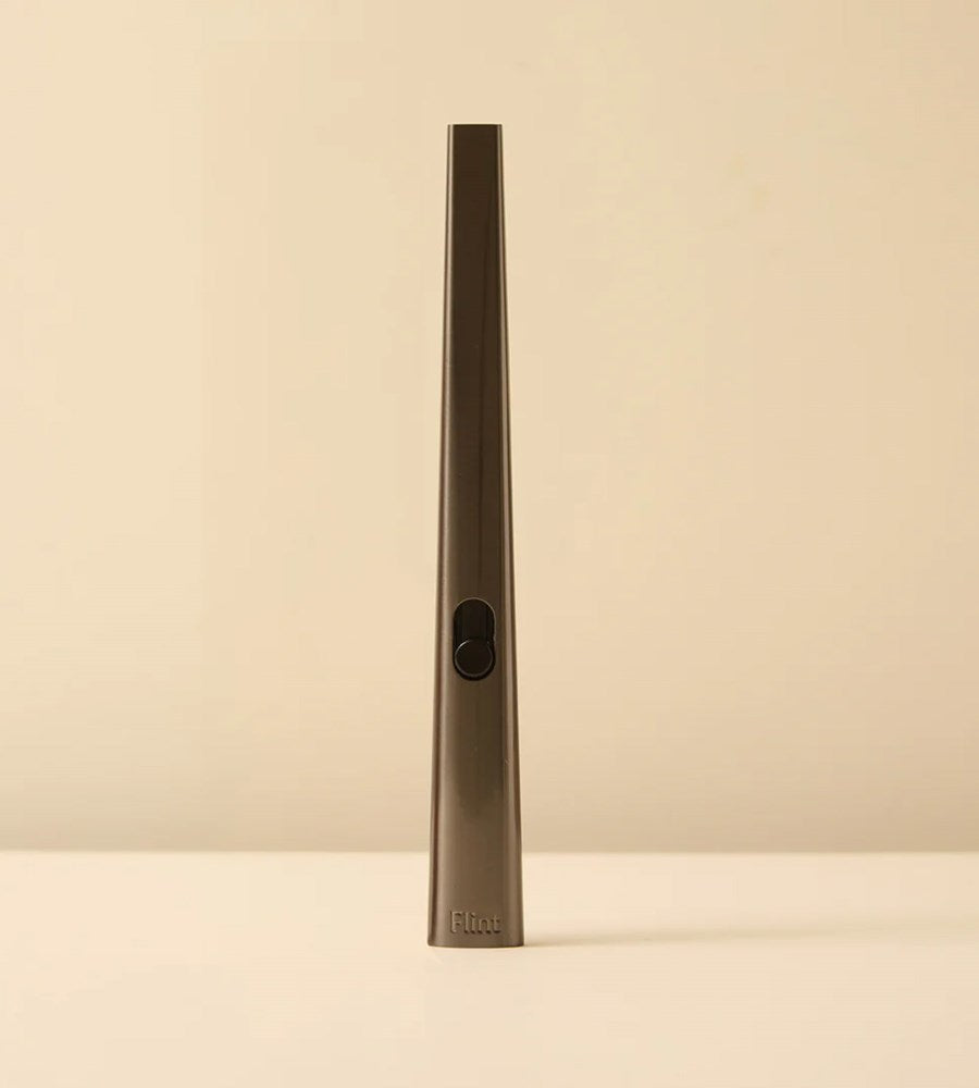 Tall, thin metallic object on a beige background