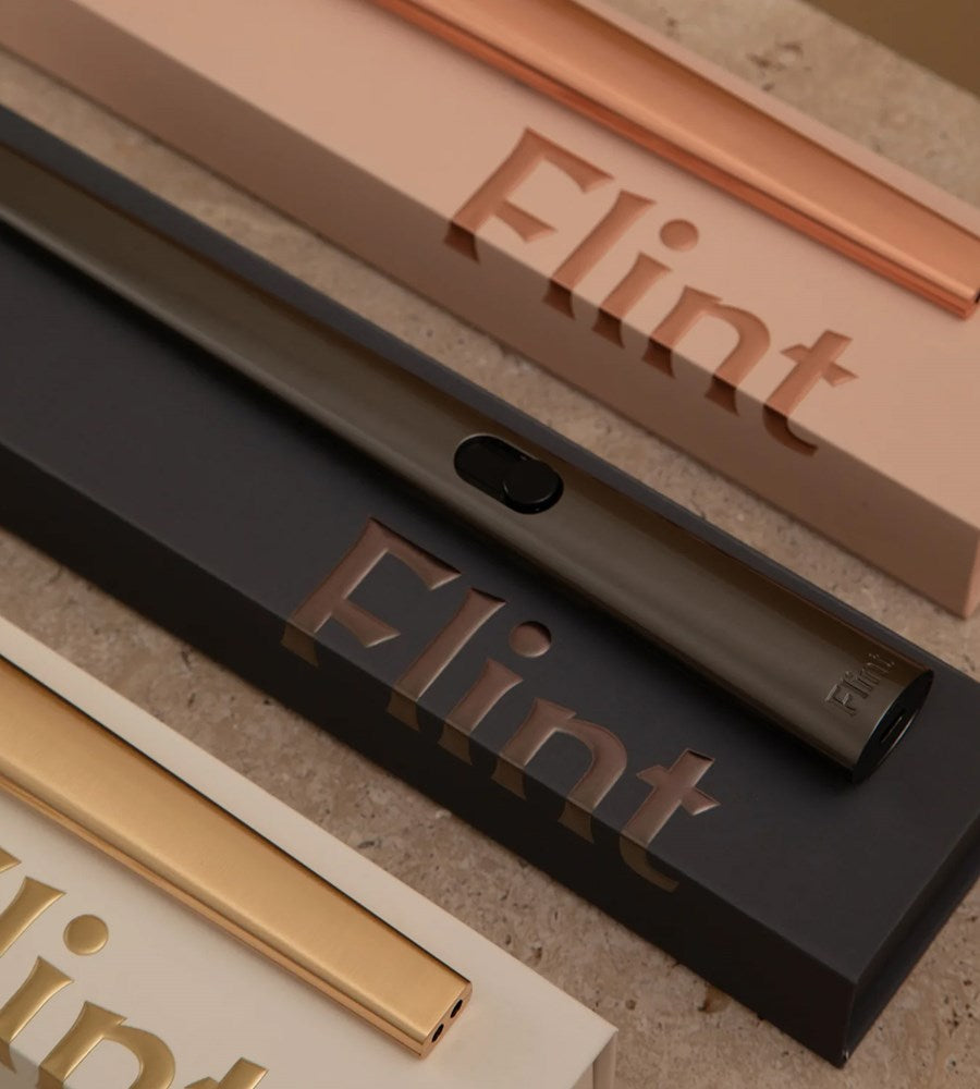 Close-up of 'Flint' products with metallic finishes on a textured surface.