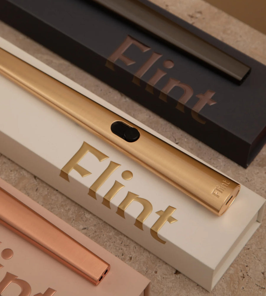 Gold and rose gold Flint products on a textured surface with 'Flint' branding.
