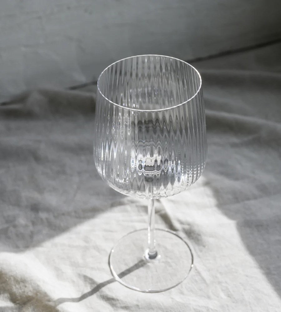 Clear glass wine glass on a textured gray surface