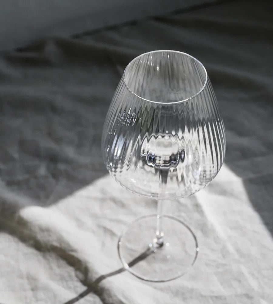 Clear glass with ribbed design on a textured surface