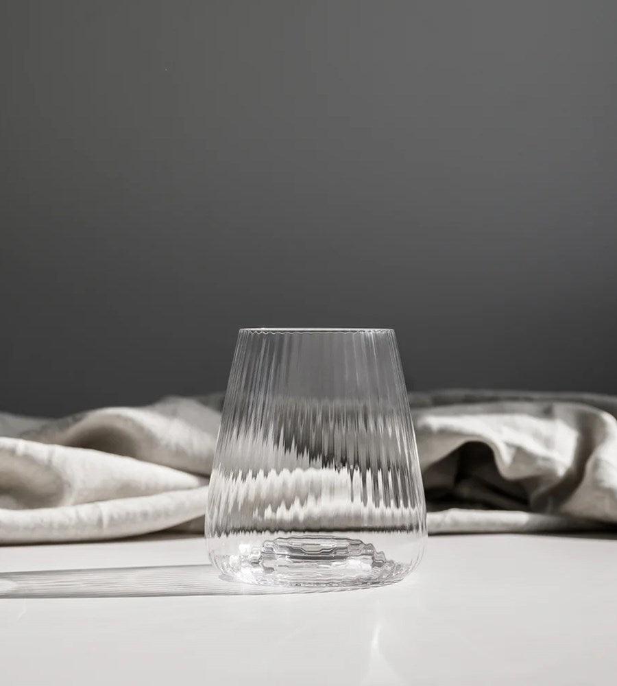 Clear glass with textured design on a gray background