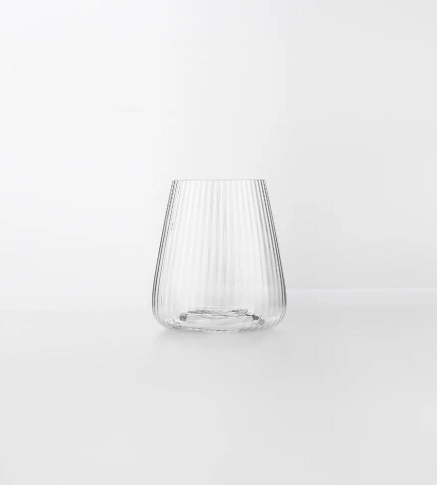 Clear glass vase with ribbed design on a white background