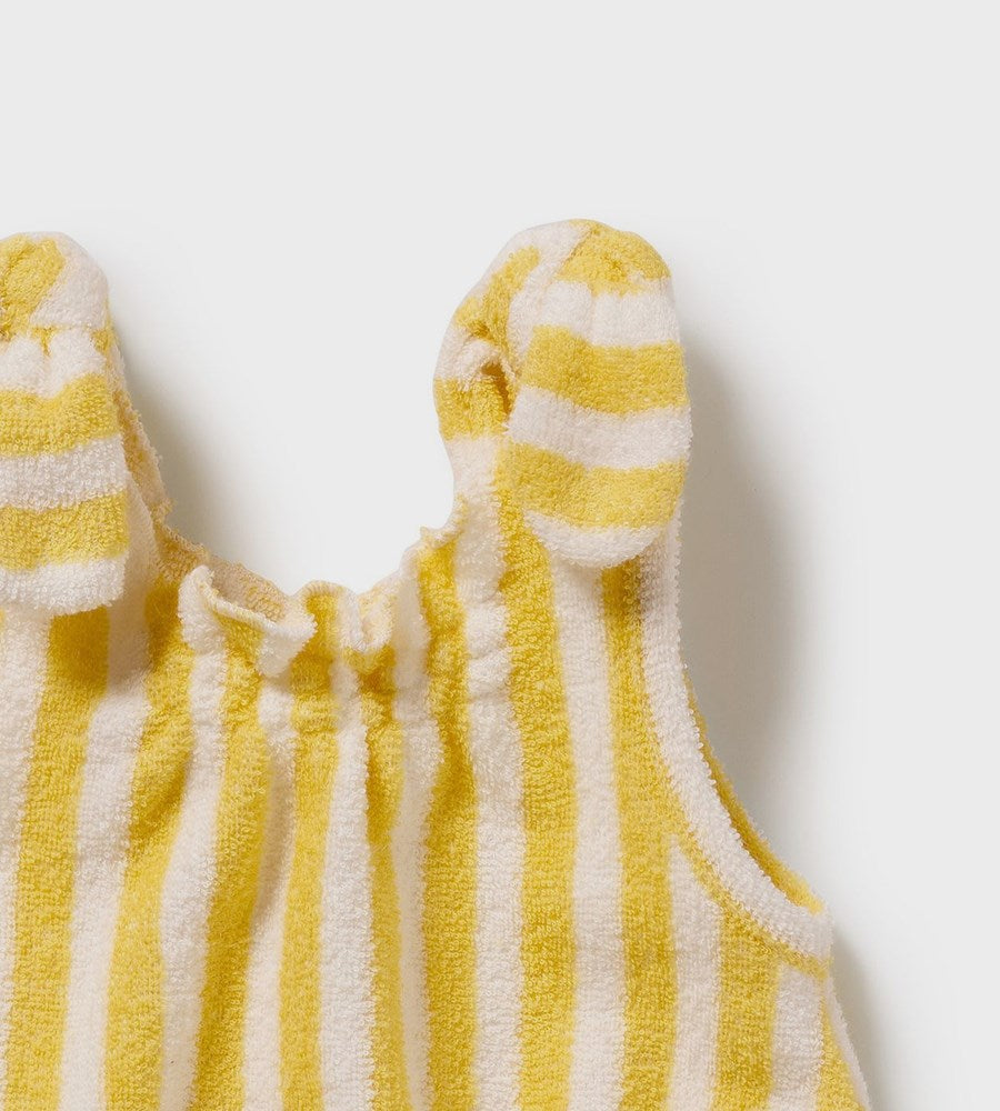 Yellow and white striped baby romper on a light gray background