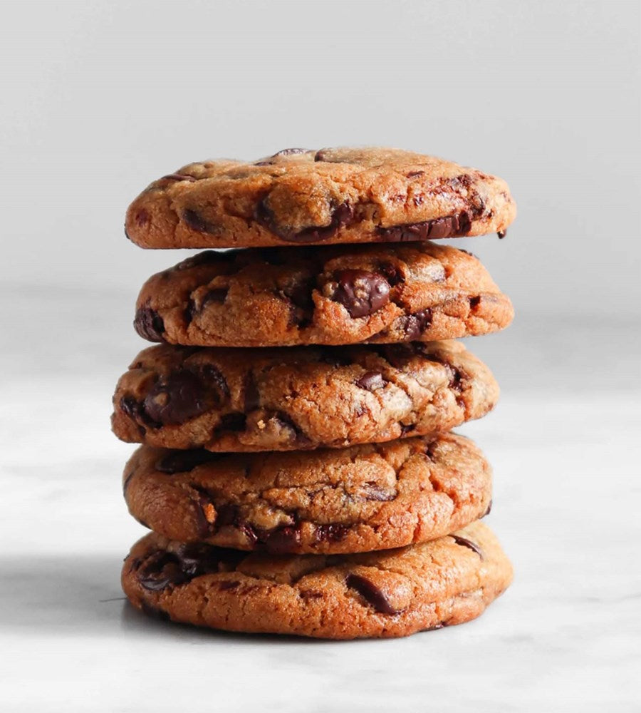 Stack of chocolate chip cookies on a light gray background