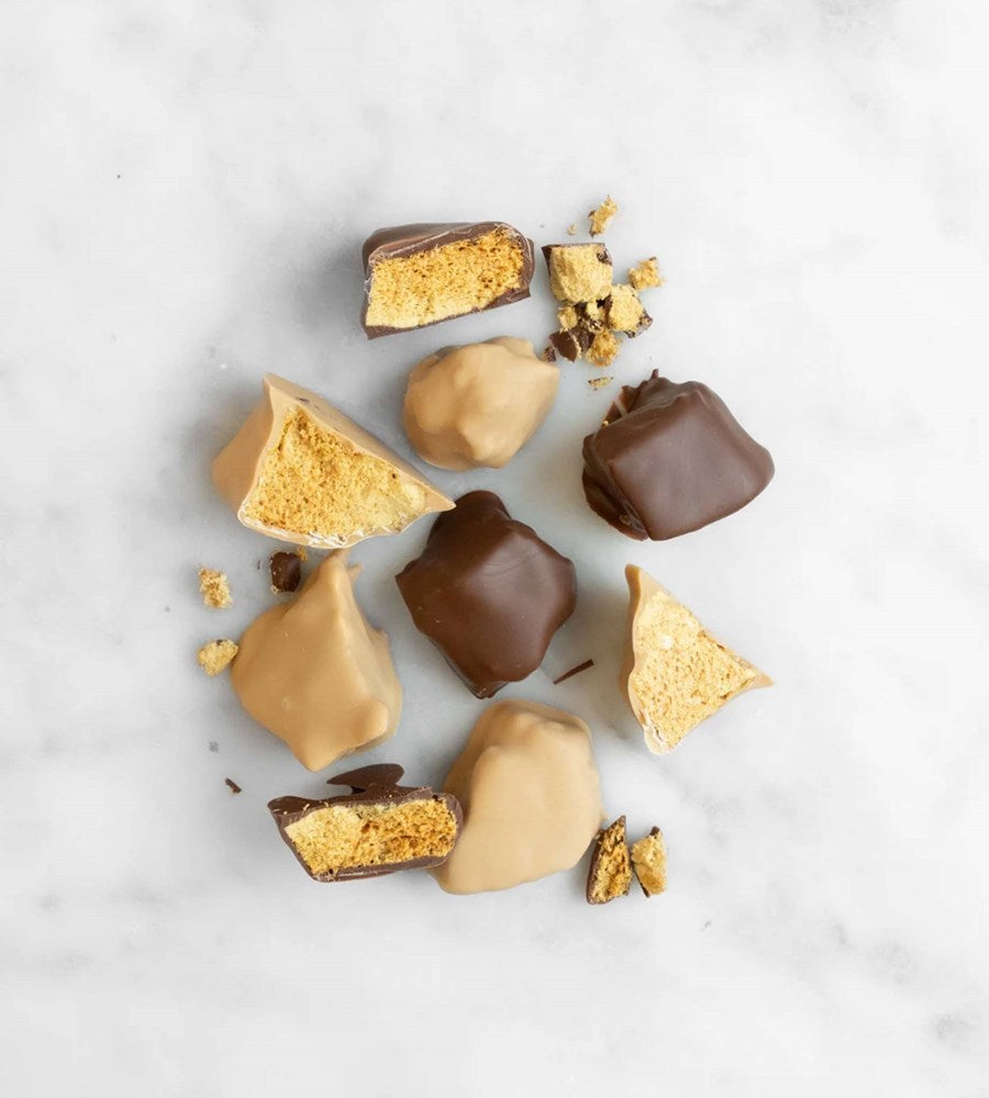 Assorted chocolate-dipped cookies on a light gray background