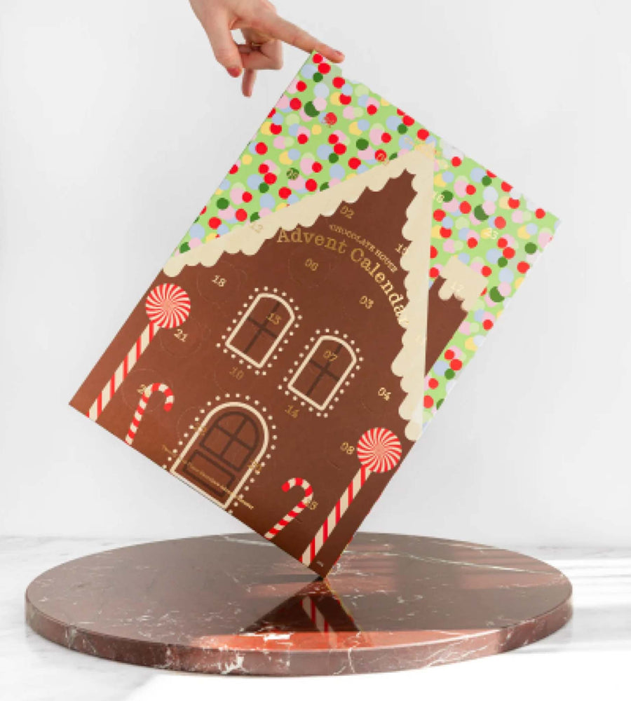 Gingerbread house-themed Advent calendar on a white background