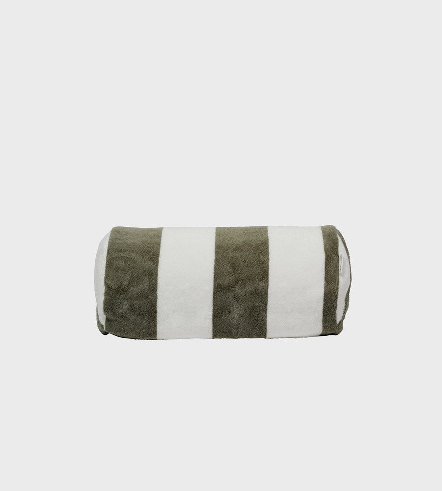 Roll of green and white striped fabric on a light gray background