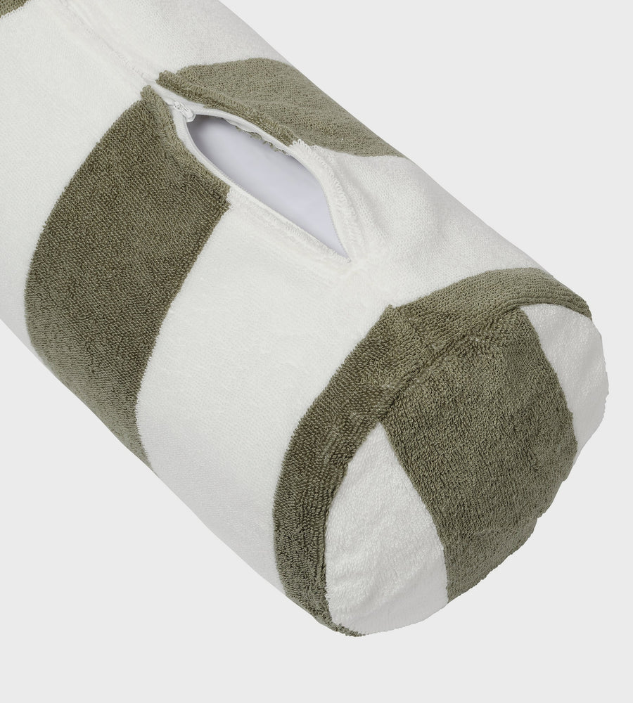 Roll of toilet paper with green towel wrapped around it on a white background