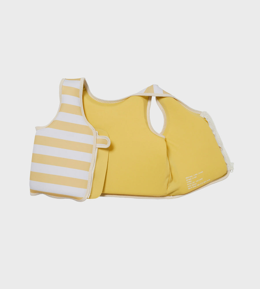 Yellow and white striped baby life jacket on a light gray background