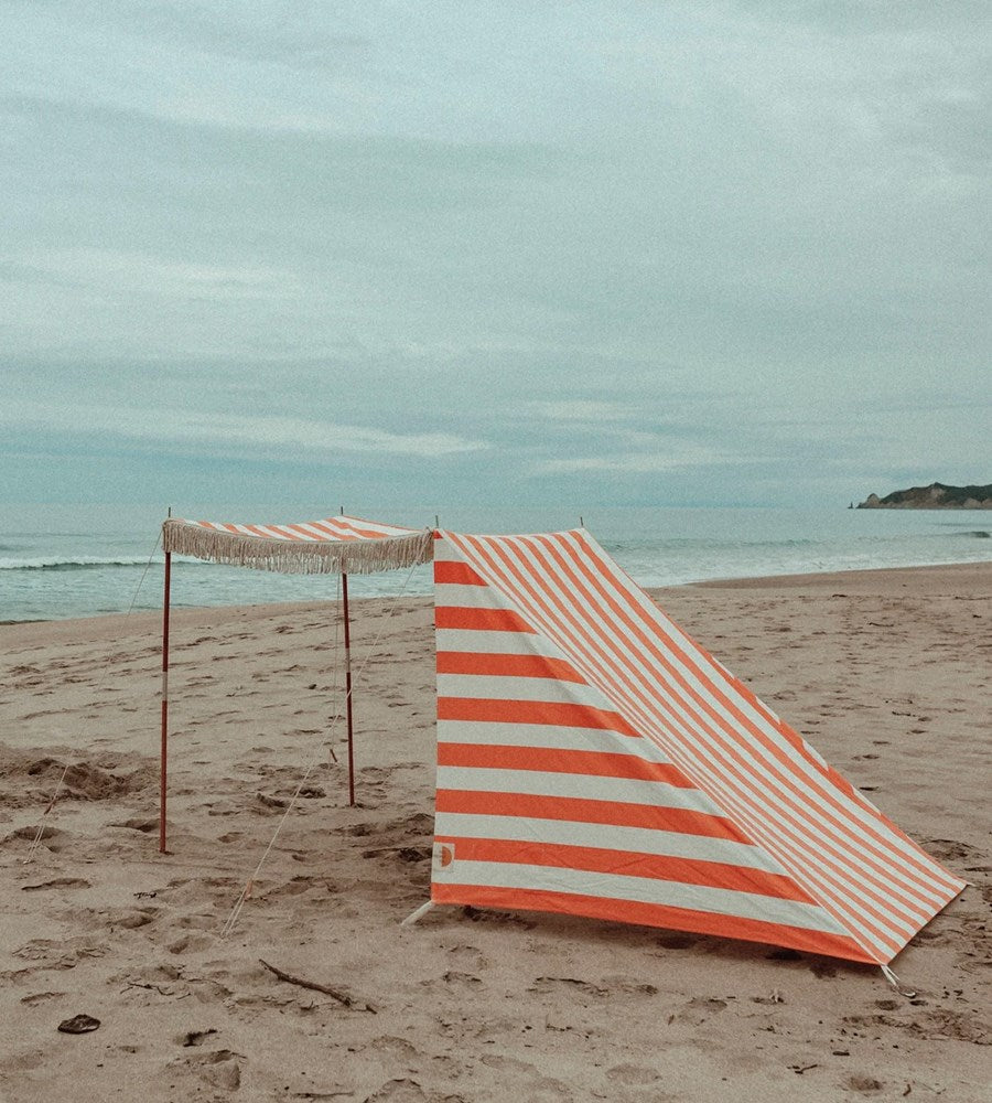 Beach umbrella with striped design on a sandy beach