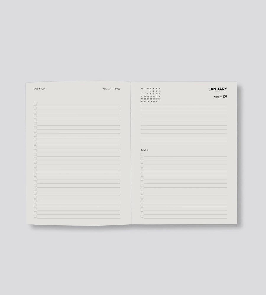 Open planner showing a calendar page and lined notes pages on a white background