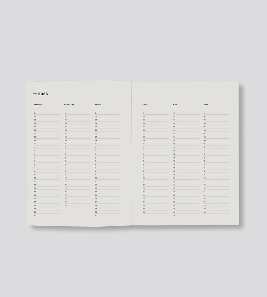 Open planner showing a monthly schedule for 2026 on a light gray background