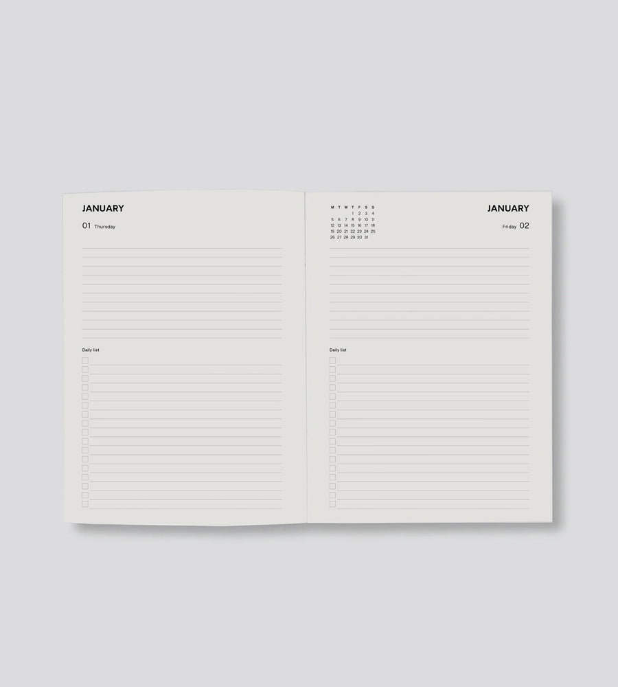 Open planner showing a two-page spread for January on a light gray background