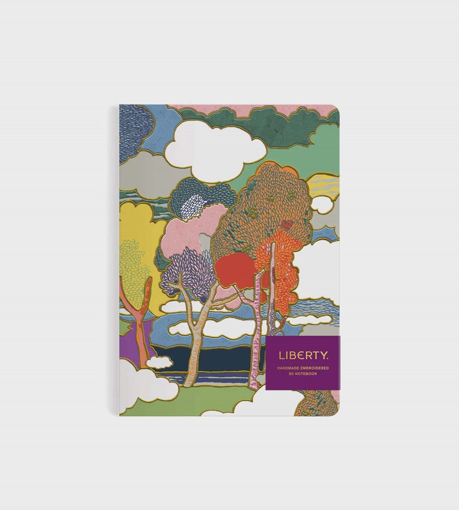 Notebook with colorful tree design on a white background