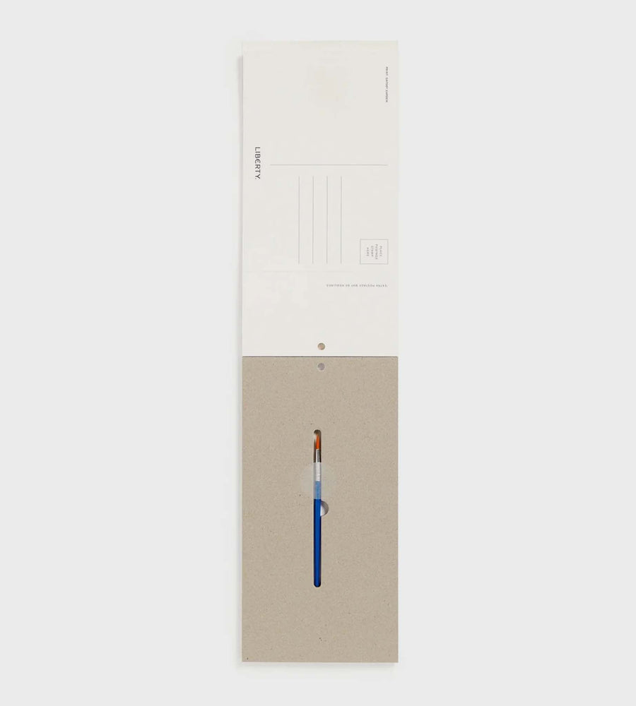 White cabinet with a beige panel featuring a pen on a white background