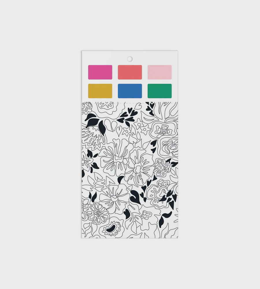 Packaging with black floral pattern and color swatches on a white background
