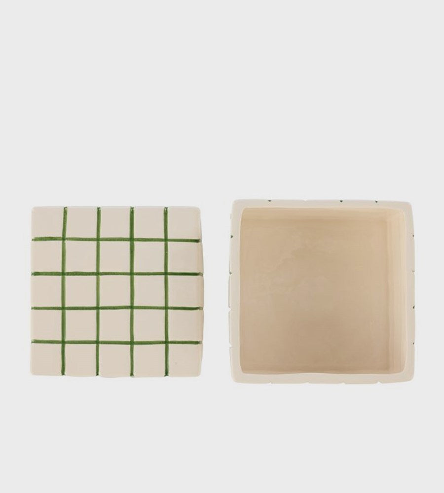 Two square items, one with a green grid pattern and the other plain beige, on a white background.
