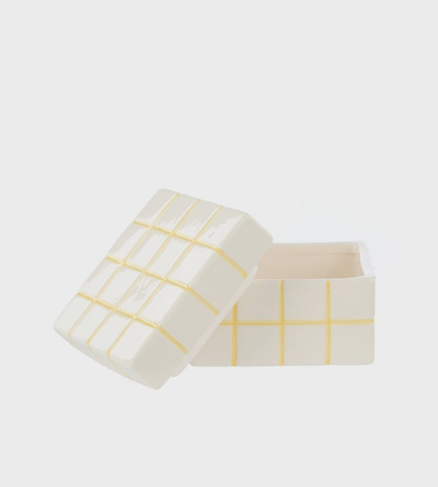 White jewelry box with yellow grid pattern on a white background