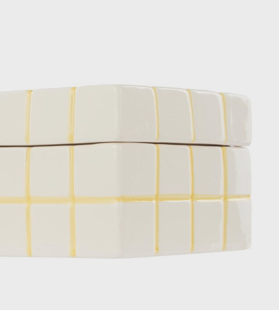 Round box with yellow grid pattern on a white background