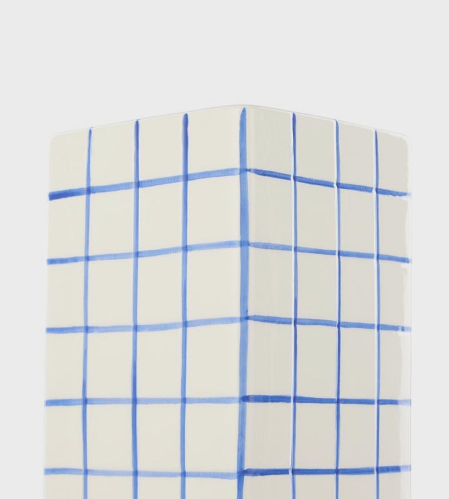 Rectangular ceramic vase with blue grid pattern on a white background