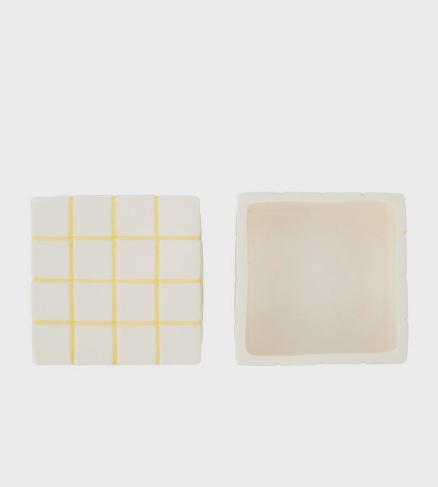 Two rectangular items on a white background, one with a yellow grid pattern and the other solid beige.