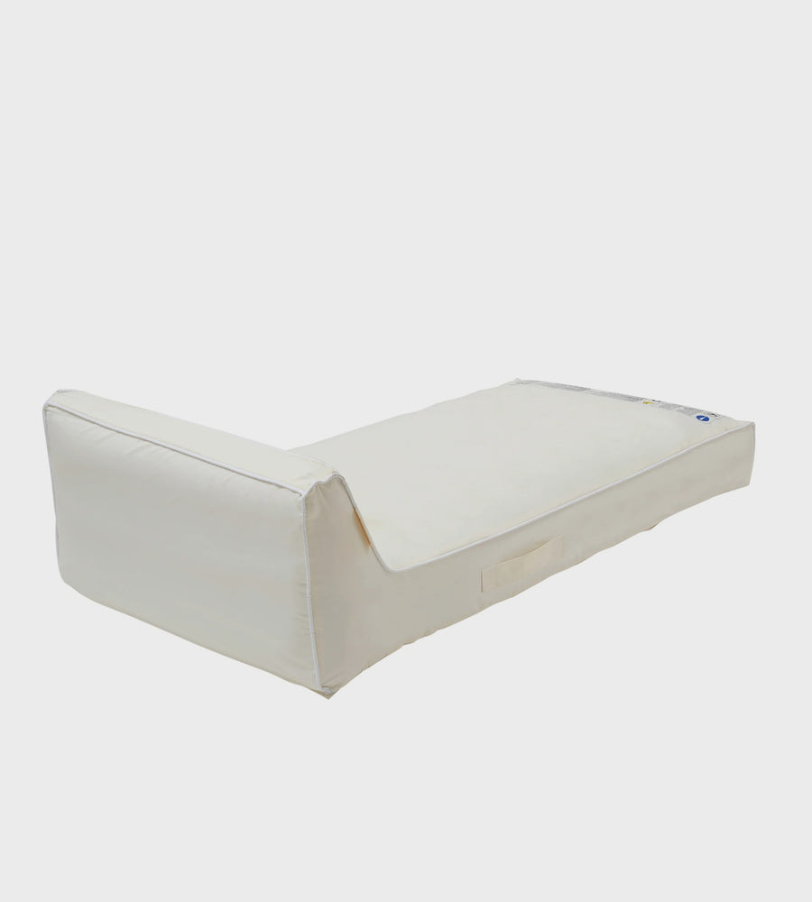 White foam mattress topper on a white background