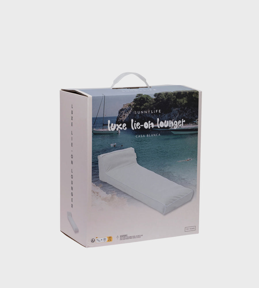 Box packaging of a lounge chair with scenic background