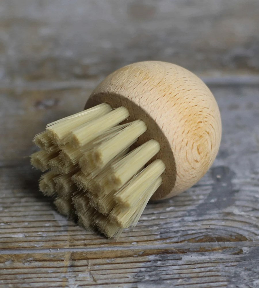 Wooden brush with a round handle.