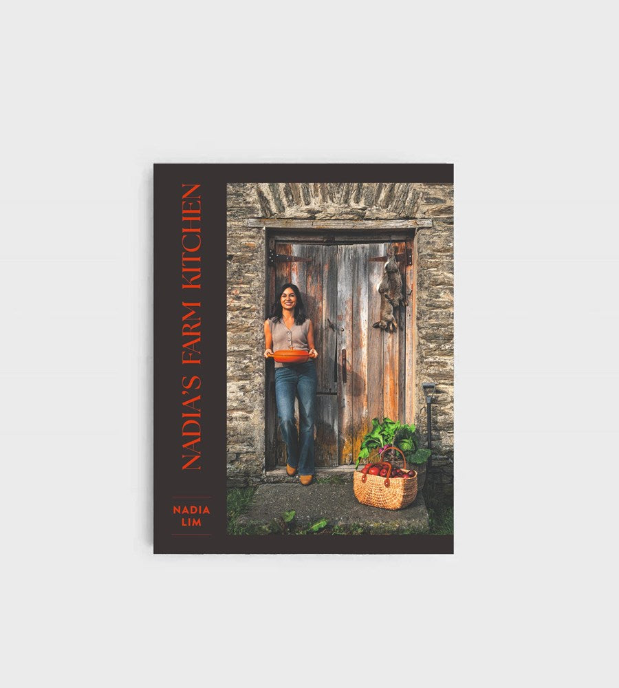 Book cover of 'Nadia's Farm Kitchen' with a woman holding a basket of vegetables in front of a rustic door.