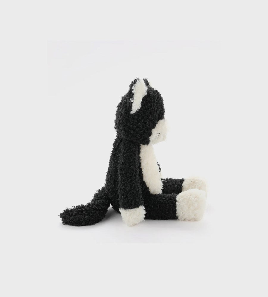 Black and white plush toy on a light gray background
