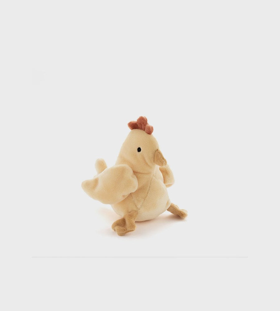 Plush toy chicken holding a piglet on a white background
