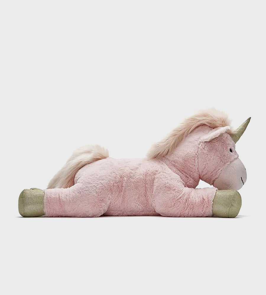 Pink plush unicorn toy on a light gray background