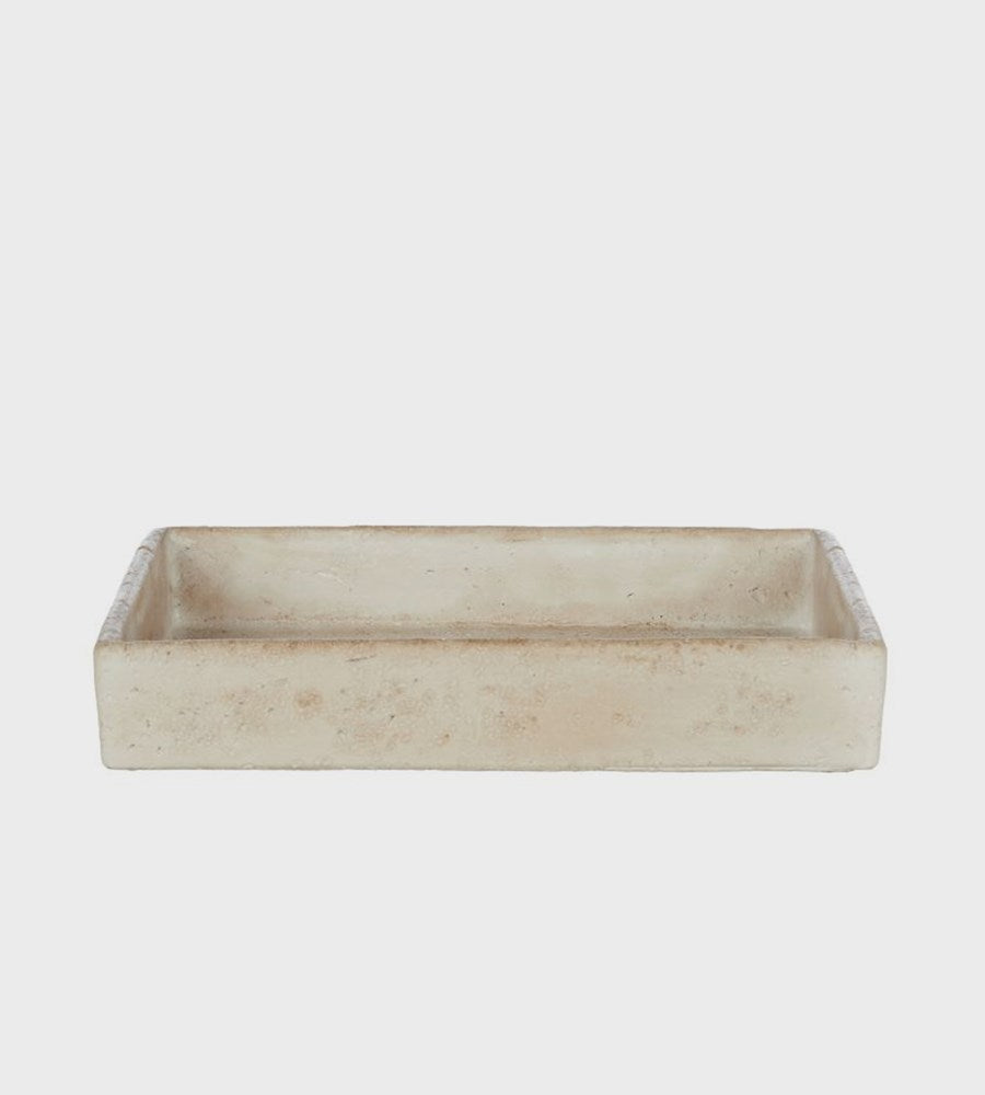 Rectangular beige stone tray on a light gray background