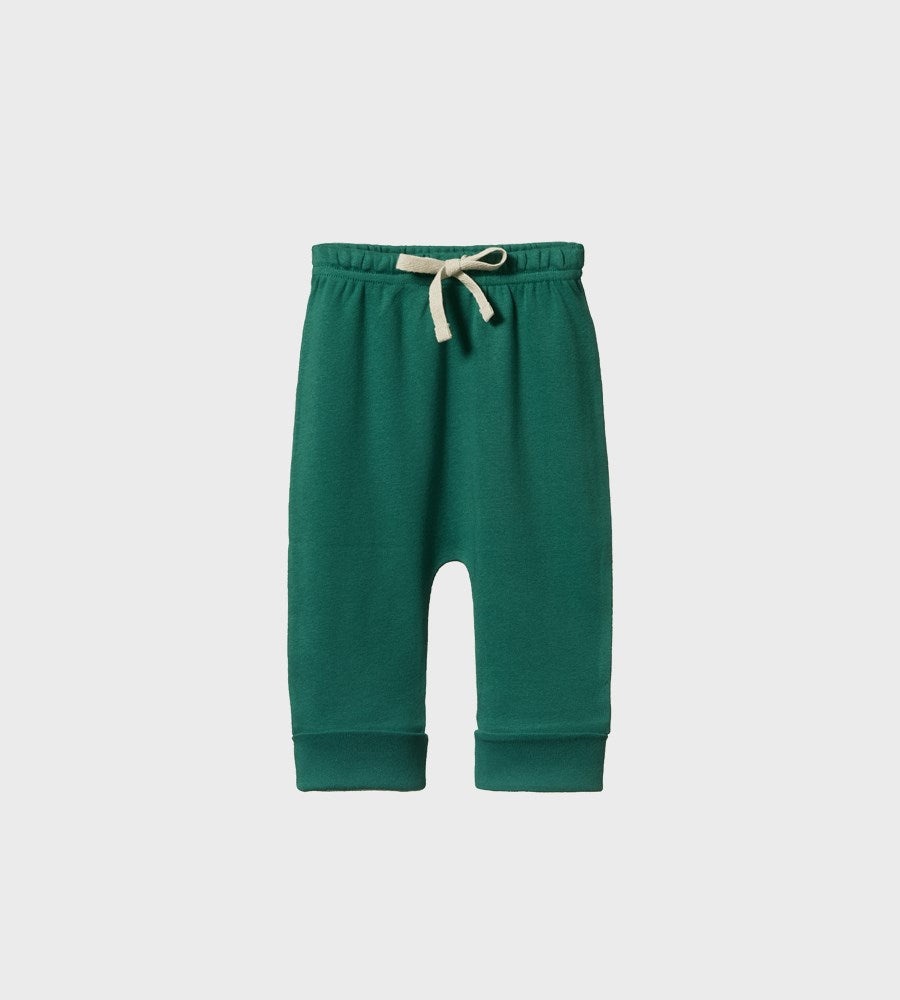 Green baby pants with a white drawstring on a light gray background