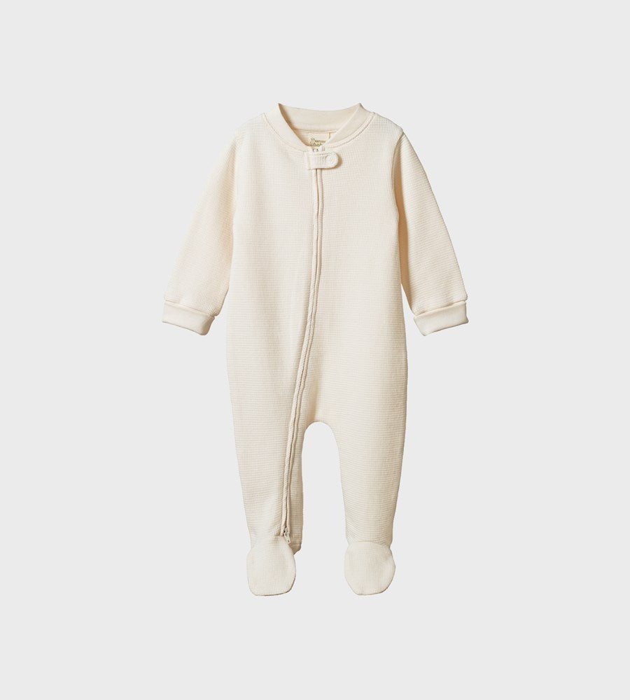 Beige baby onesie with a zipper on a white background