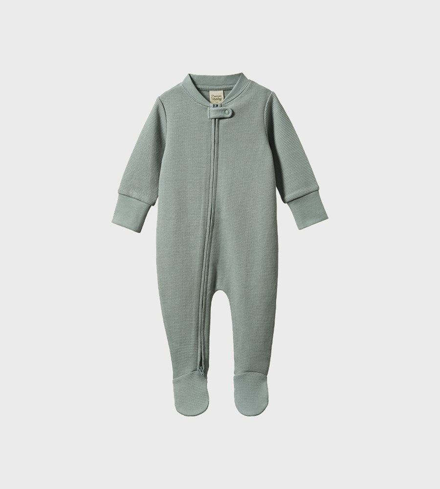 Green baby onesie with a zipper on a white background
