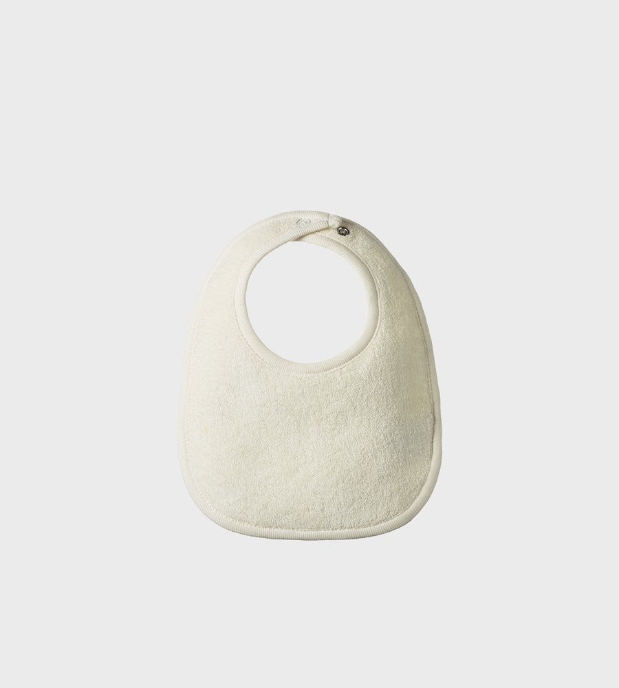 Beige baby bib on a light gray background