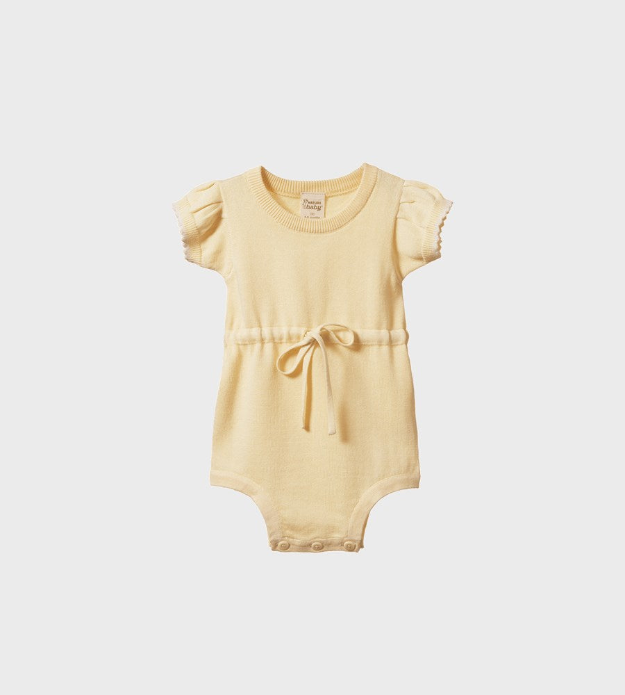 Yellow baby romper with ruffled sleeves on a light gray background