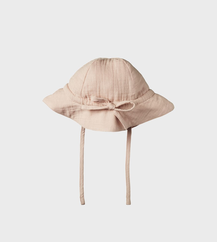 Beige baby hat with a bow on a white background