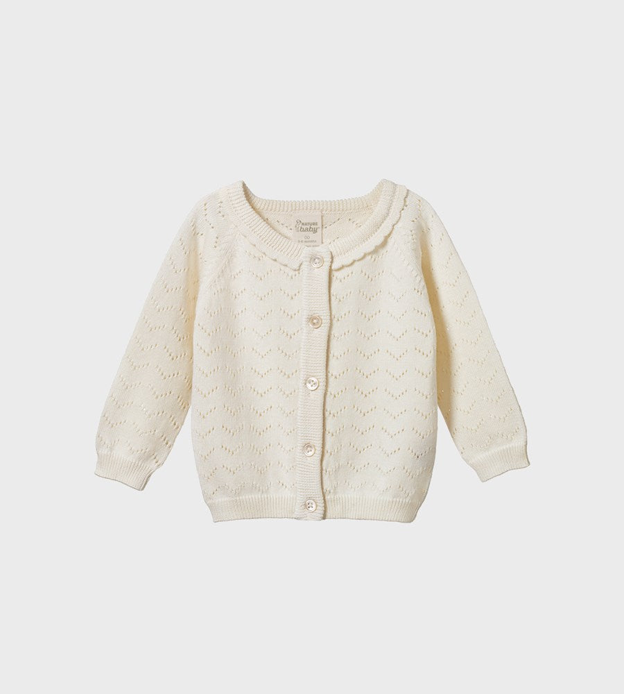 Cream-colored baby cardigan on a white background