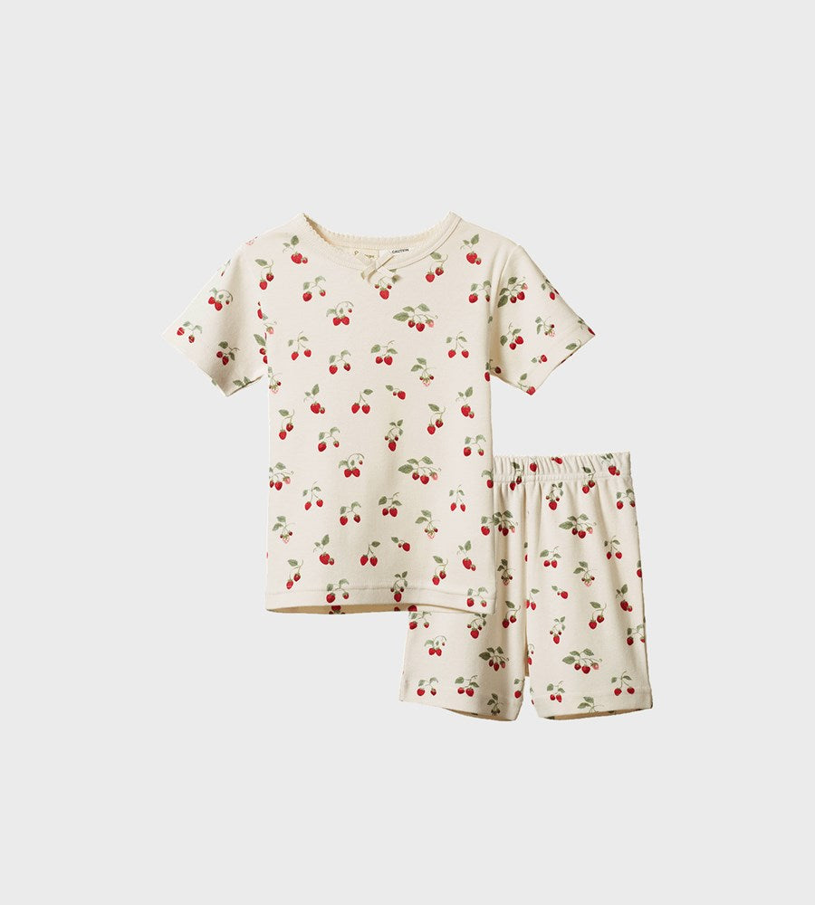 Children's pajama set with cherry pattern on a white background