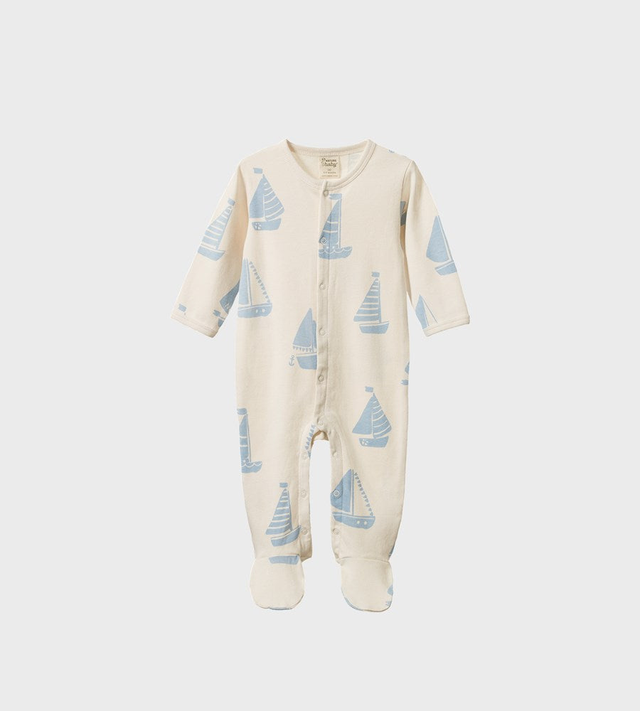 Baby onesie with sailboat pattern on a white background