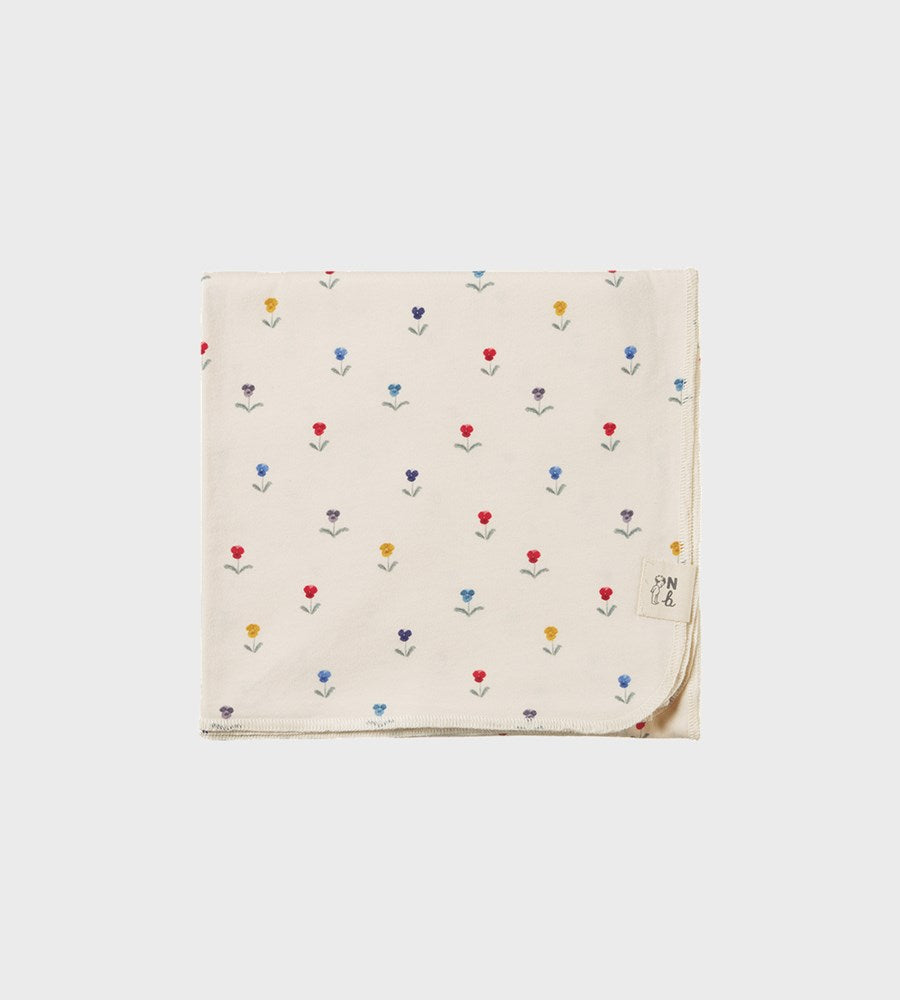 Beige fabric with colorful flower pattern on a white background